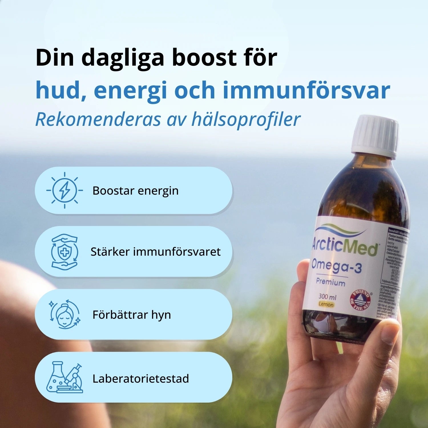One amber glass bottle of ArcticMed Omega-3 Premium 300 ml Lemon held by a hand against a blurred outdoor background.